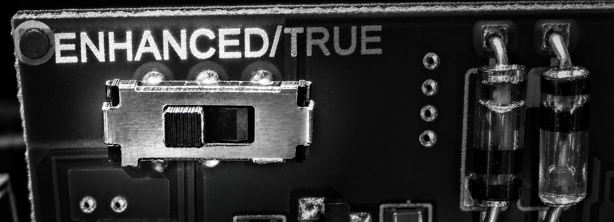 Grayscale circuit-board detail with the ENHANCED label and bypass selector highlighted